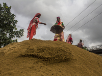 Women during the Day labors are working in a domestic port in Dhaka, Bangladesh, on 14 August 2018. (