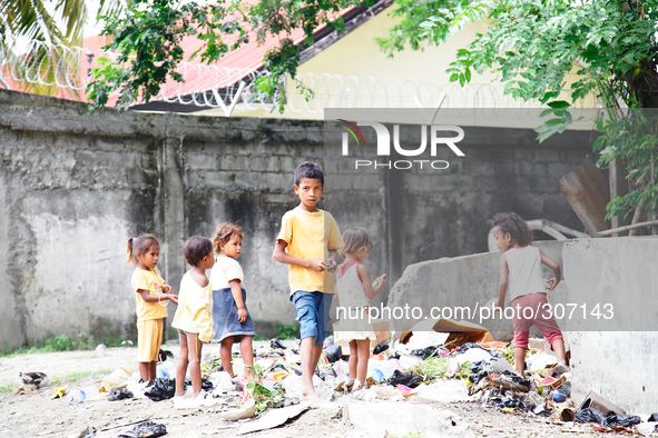 A 'team' of Timorese children search rubbish for anything of value. 