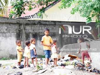 A 'team' of Timorese children search rubbish for anything of value. (