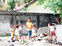 A 'team' of Timorese children search rubbish for anything of value. (