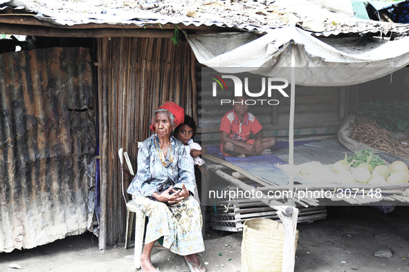 Grandma minding children at a Market near Dili. 