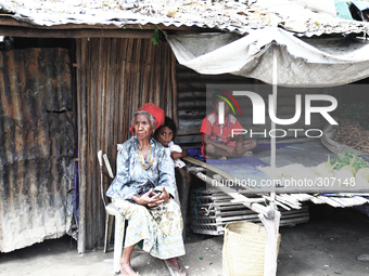 Grandma minding children at a Market near Dili. (