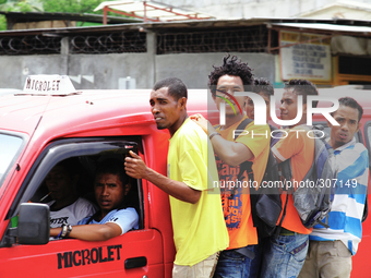 Timor Leste uni students hitching a ride on a Microlet leading Dili for the districts. (