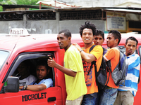 Timor Leste uni students hitching a ride on a Microlet leading Dili for the districts. (