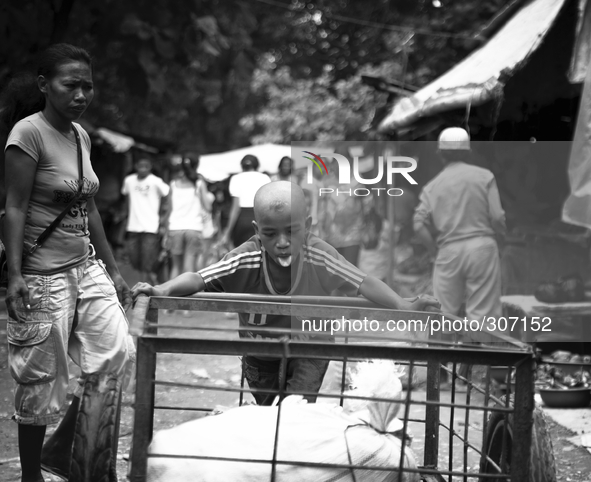 A young boy working for $1 a day at one of Timor Leste's markets. 