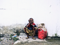 An elderly Timorese woman waiting for a Microlet to go back to the Districts of Timor Lest (