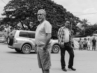 An iPhone image of Timor Leste Prime Minister Xanana Gusmao (and bodyguard) warning unemployed youth not to throw stones. (