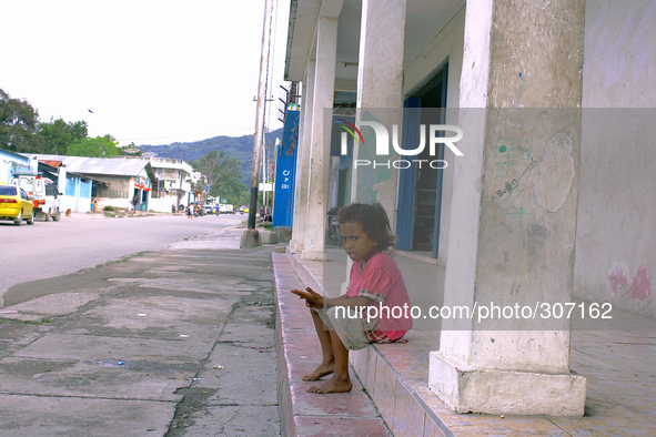 A young girl in the poor neighbourhood of Culuhun sits by the roadside. 