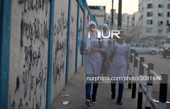 palestinian school girls walk at the Gaza City, on the first day of a new school year, in Gaza City August 29, 2018. 
 