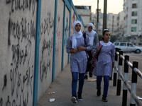 palestinian school girls walk at the Gaza City, on the first day of a new school year, in Gaza City August 29, 2018. 
 (