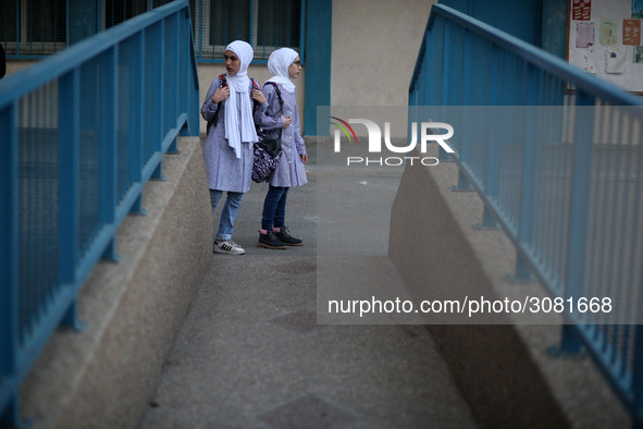 palestinian school girls walk at the Gaza City, on the first day of a new school year, in Gaza City August 29, 2018. 
 