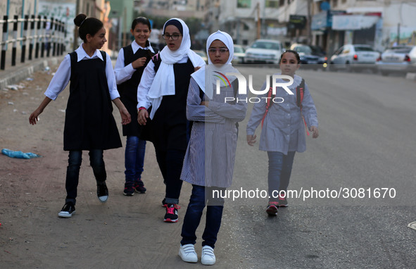 palestinian school girls walk at the Gaza City, on the first day of a new school year, in Gaza City August 29, 2018. 
 