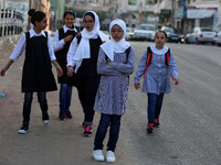 palestinian school girls walk at the Gaza City, on the first day of a new school year, in Gaza City August 29, 2018. 
 (