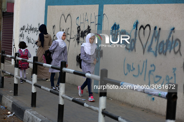 palestinian school girls walk at the Gaza City, on the first day of a new school year, in Gaza City August 29, 2018. 
 