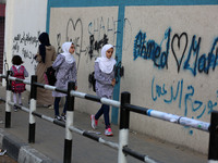 palestinian school girls walk at the Gaza City, on the first day of a new school year, in Gaza City August 29, 2018. 
 (