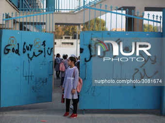 palestinian school girls walk at the Gaza City, on the first day of a new school year, in Gaza City August 29, 2018. 
 (