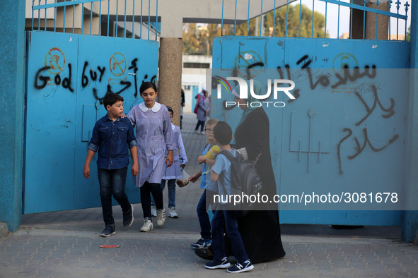 palestinian school girls walk at the Gaza City, on the first day of a new school year, in Gaza City August 29, 2018. 
 