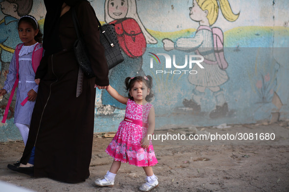 palestinian school girls walk at the Gaza City, on the first day of a new school year, in Gaza City August 29, 2018. 
 