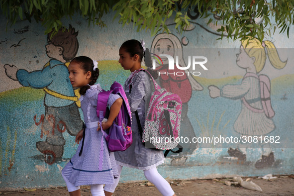 palestinian school girls walk at the Gaza City, on the first day of a new school year, in Gaza City August 29, 2018. 
 