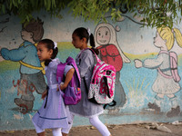 palestinian school girls walk at the Gaza City, on the first day of a new school year, in Gaza City August 29, 2018. 
 (