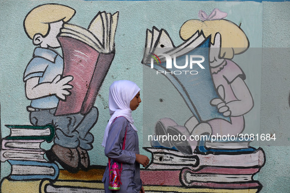 palestinian school girls walk at the Gaza City, on the first day of a new school year, in Gaza City August 29, 2018. 
 