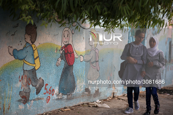 palestinian school girls walk at the Gaza City, on the first day of a new school year, in Gaza City August 29, 2018. 
 