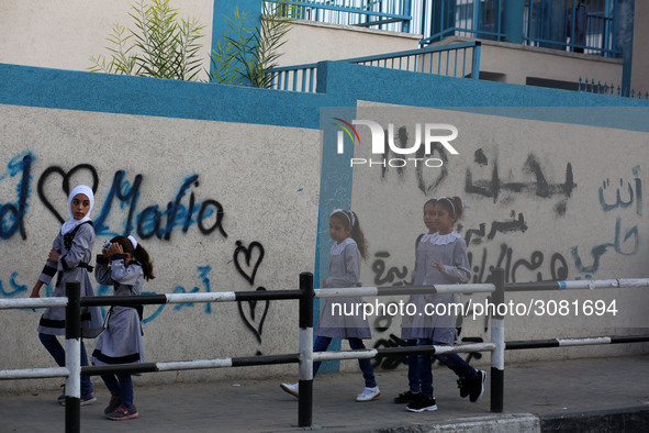 palestinian school girls walk at the Gaza City, on the first day of a new school year, in Gaza City August 29, 2018. 
 