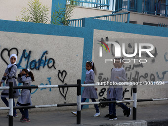 palestinian school girls walk at the Gaza City, on the first day of a new school year, in Gaza City August 29, 2018. 
 (