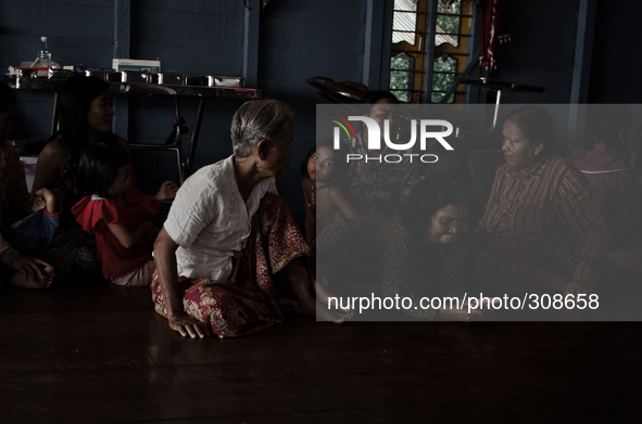 Phumi Moat Khla, Tonle Sap, Cambodia. A family sit and await desperately needed medical treatment in a  floating medical clinic situated dee...