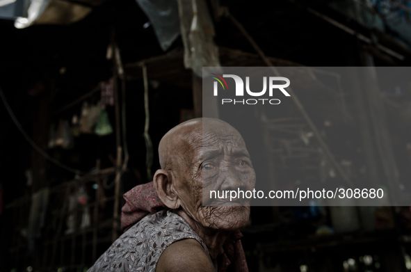 Kampong Pluk, Tonle Sap, Cambodia. An elderly woman suffering from cataracts and unable to afford medication struggles through her day slowl...