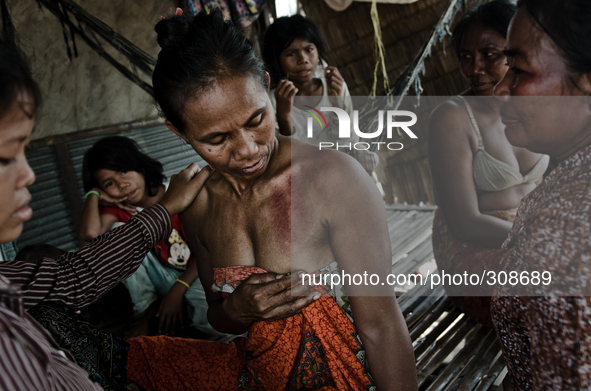 Phnom Krom, Tonle Sap, Cambodia. Traditional remedies and beliefs are still very much prevelent in isolated communities living on and surrou...