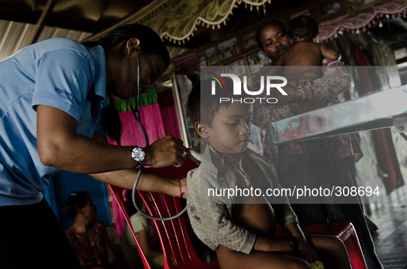 Phumi Stoeng Chrou, Tonle Sap, Cambodia. A child suffering from intestinal worms receives much needed care at a make shift clinic in the vil...