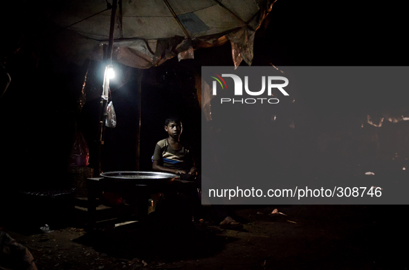 Kampong Pluk, Tonle Sap, Cambodia. A young boy finishes selling his days catch, Cambodia may lose up to 42 percent of its freshwater fish by...