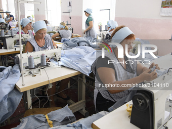 People at work in a factory for fabric tailoring, in Skvyra, Ukraine, on September 3, 2018. (