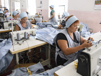 People at work in a factory for fabric tailoring, in Skvyra, Ukraine, on September 3, 2018. (