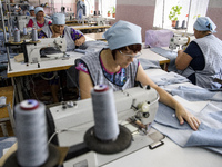 People at work in a factory for fabric tailoring, in Skvyra, Ukraine, on September 3, 2018. (