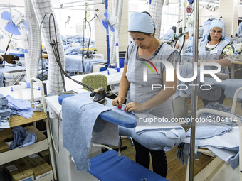 People at work in a factory for fabric tailoring, in Skvyra, Ukraine, on September 3, 2018. (