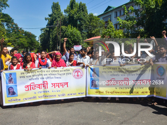 Cotton University and Handique Girls College students stage a protest by blocking road in front of office of the Deputy Commissioner, Kamrup...