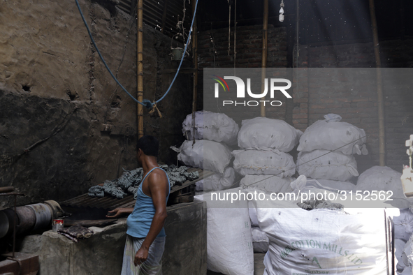 Women work in a polythene bag recycling factory in Kamrangirchar, Dhaka Bangladesh, on September 14, 2018. 