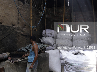 Women work in a polythene bag recycling factory in Kamrangirchar, Dhaka Bangladesh, on September 14, 2018. (