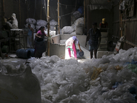 Women work in a polythene bag recycling factory in Kamrangirchar, Dhaka Bangladesh, on September 14, 2018. (