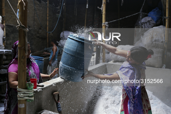 Women work in a polythene bag recycling factory in Kamrangirchar, Dhaka Bangladesh, on September 14, 2018. 