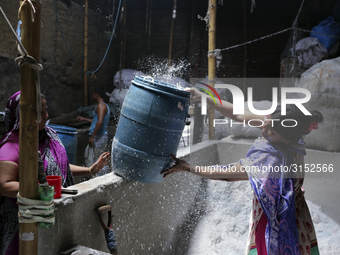 Women work in a polythene bag recycling factory in Kamrangirchar, Dhaka Bangladesh, on September 14, 2018. (