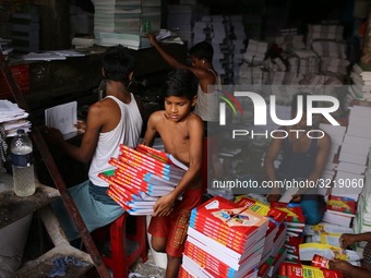 Children are working on a book binding factory in Dhaka, 27 September 2018.  (