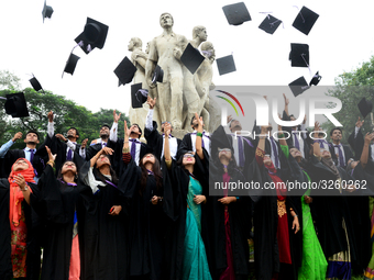 A group of graduates expressing their delight in front of the sculpture Raju at TSC area, on the 51th convocation of the students of Dhaka U...