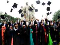 A group of graduates expressing their delight in front of the sculpture Raju at TSC area, on the 51th convocation of the students of Dhaka U...