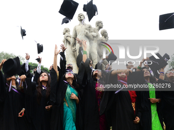 A group of graduates expressing their delight in front of the sculpture Raju at TSC area, on the 51th convocation of the students of Dhaka U...