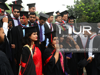 A group of graduates expressing their delight in front of the sculpture Raju at TSC area, on the 51th convocation of the students of Dhaka U...