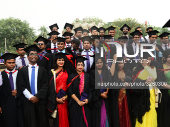 A group of graduates expressing their delight in front of the sculpture Raju at TSC area, on the 51th convocation of the students of Dhaka U...