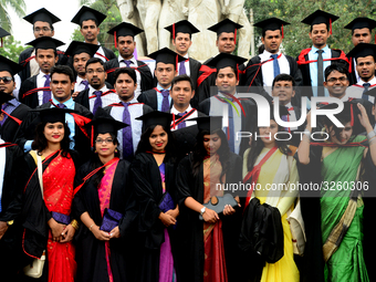 A group of graduates expressing their delight in front of the sculpture Raju at TSC area, on the 51th convocation of the students of Dhaka U...